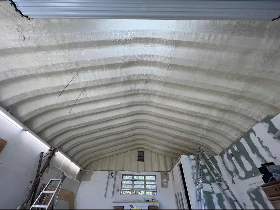 Spray polyurethane foam applied to the underside of a metal roof deck in Buford